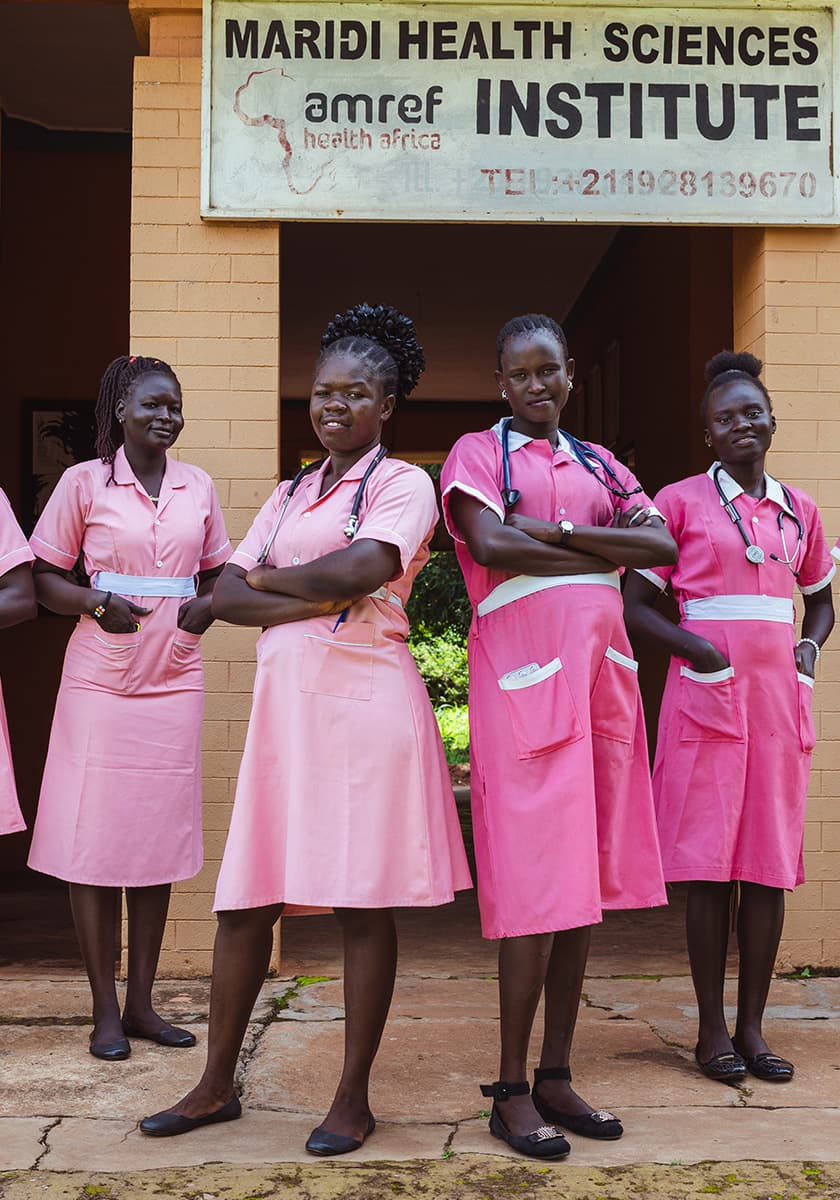 Foto von Krankenschwestern die vor einem Ktankenhaus zusammenstehen.