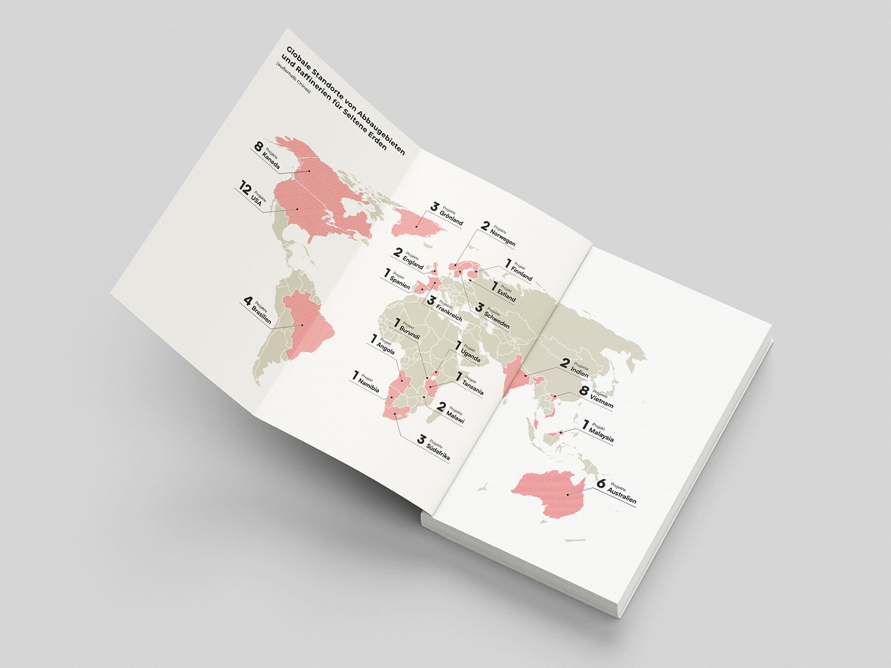 Mock-up der Weltkarte zu Rohstoff-Abbaugebieten und Ressourcen auf Vorsatzblatt im Buch, Wickelfalz ausgeklappt